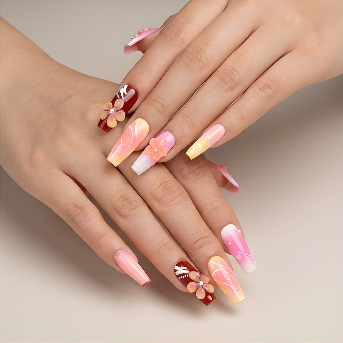 Sunset Sorbet – pink, peach and lemon ombre coffin press-on nails with 3D flowers and gold foil worn on hand