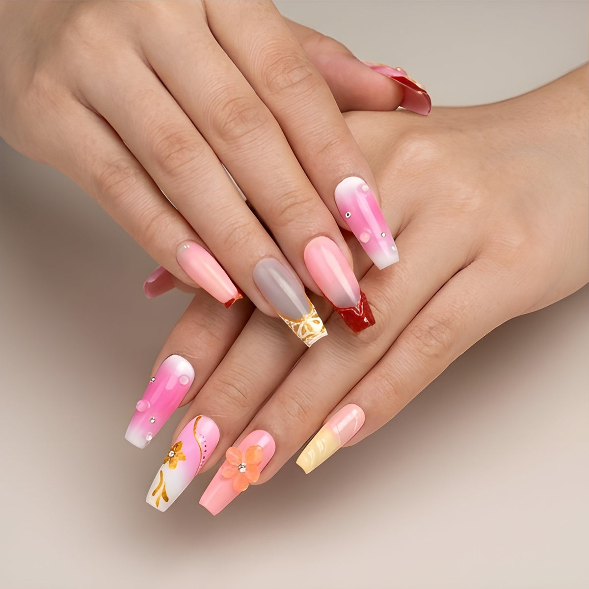 Sunset Sorbet – pink, peach and lemon ombre coffin press-on nails with 3D flowers and gold foil worn on hand