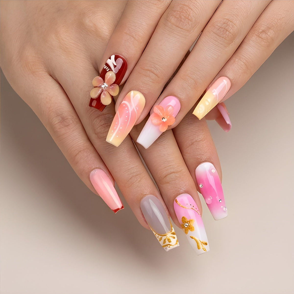 Sunset Sorbet – pink, peach and lemon ombre coffin press-on nails with 3D flowers and gold foil worn on hand